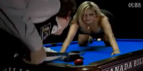 What does a blonde woman on the pool table?