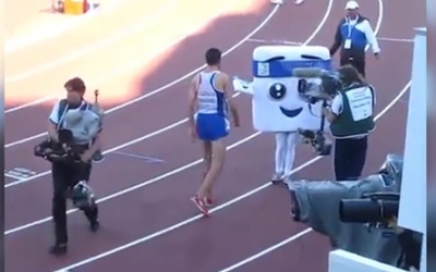 Runner wins the race and then pushes a mascot!