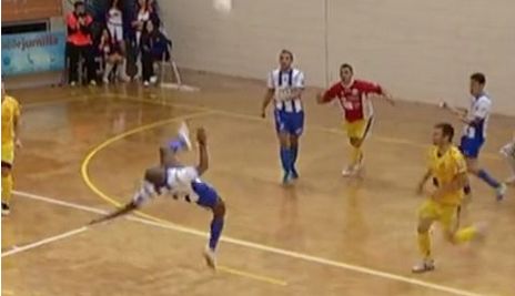 Futsal player scores spectacular goal from his own half!