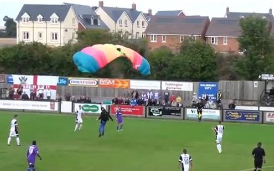 Parachutist lands on pitch during a football game!