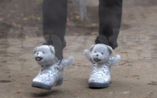 A footballer wears teddy bear sneakers
